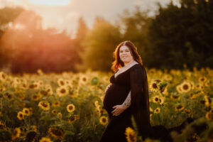outdoor golden hour maternity session in a sunflower field in bathurst using black gown client wardrobe