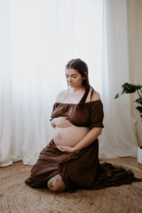 cozy studio maternity photoshoot with brown dress