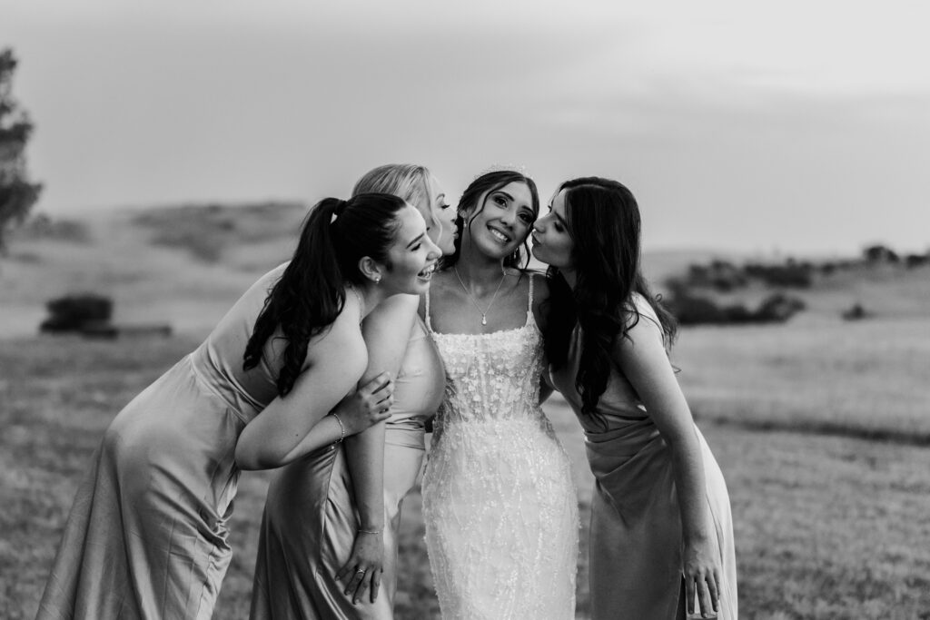 Bride and her girls shot agains rolling central west hills at The Hayshed