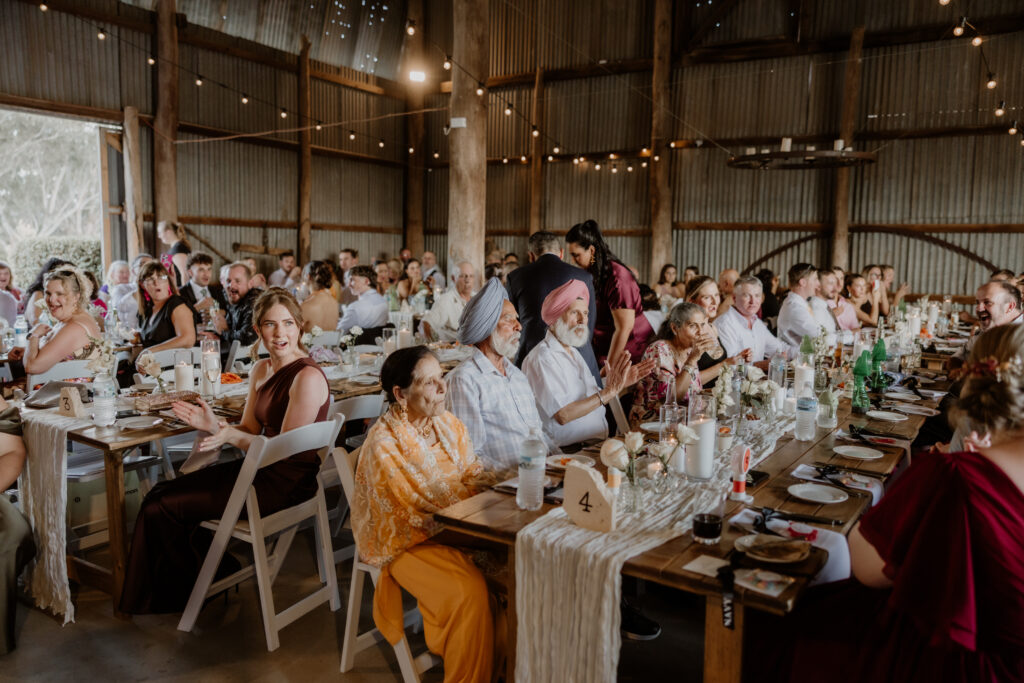 Guests seated at a rustic wedding at The Hayshed, photographed by Central west wedding photographer Meredith Photography